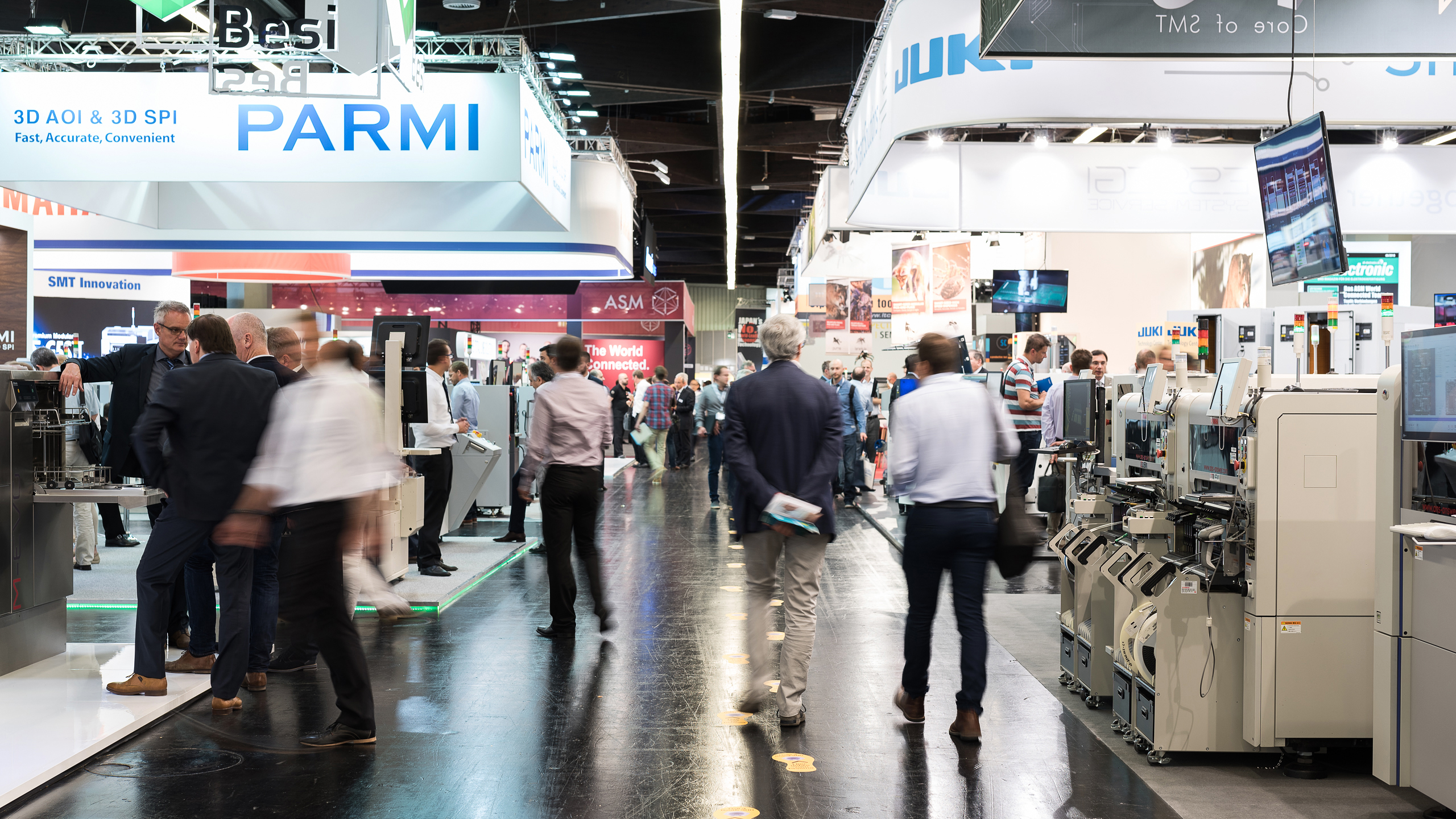 Trade fair atmosphere in hall 4 with Panasonic Industry Europe GmbH, JUKI Automation Systems GmbH, and more