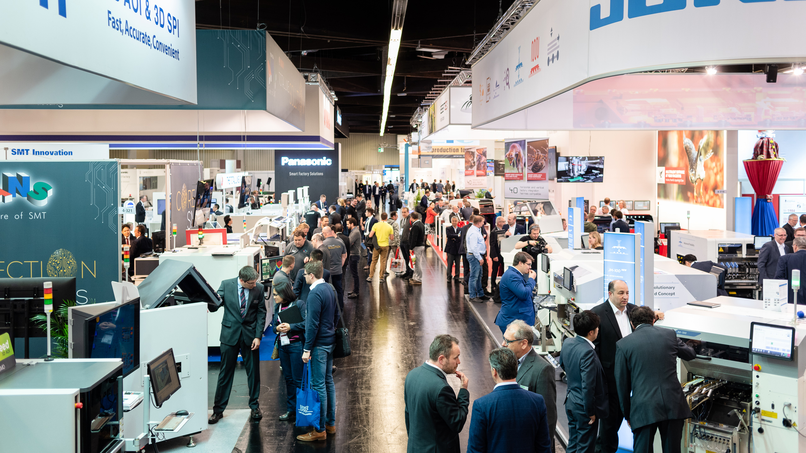 Trade fair atmosphere in hall 4: Panasonic Industry Europe GmbH, JUKI Automation Systems GmbH, and more